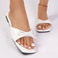Kaelen Summer Breeze flat sandals in white patent PU, featuring a chic bow embellishment and open square toe, shown on model's feet.