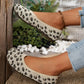 Women's Kaelen leopard print knit ballet flats, showcasing a comfortable slip-on design with a creamy off-white base and black/brown spots, styled with denim.