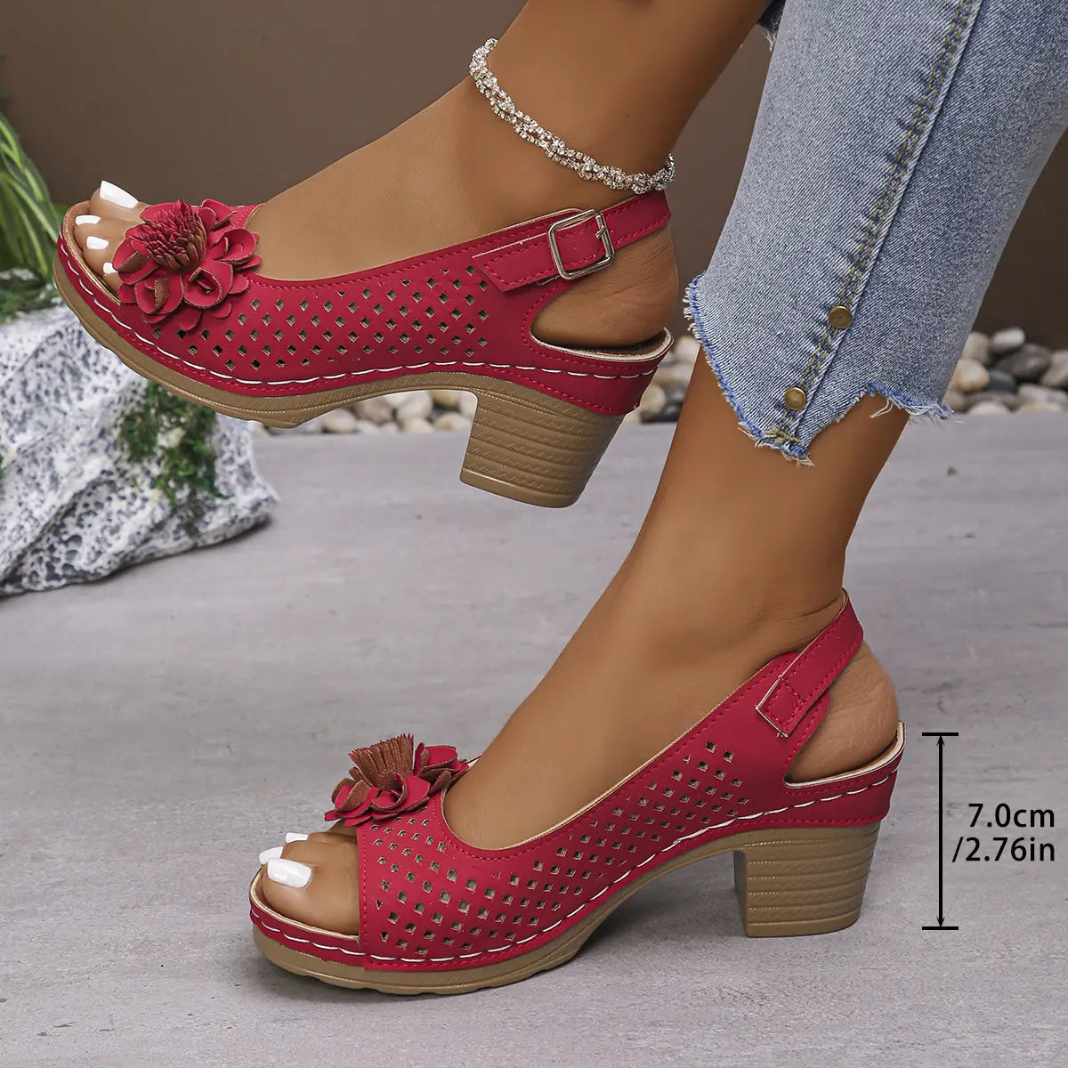 Kaelia red peep-toe chunky heel sandals with floral embellishment and square perforations, worn by a model with jeans and an anklet.