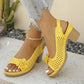 Sunny Marigold Kaelia chunky heel sandals with floral embellishment and perforated peep-toe design, shown on a model's feet with denim jeans.