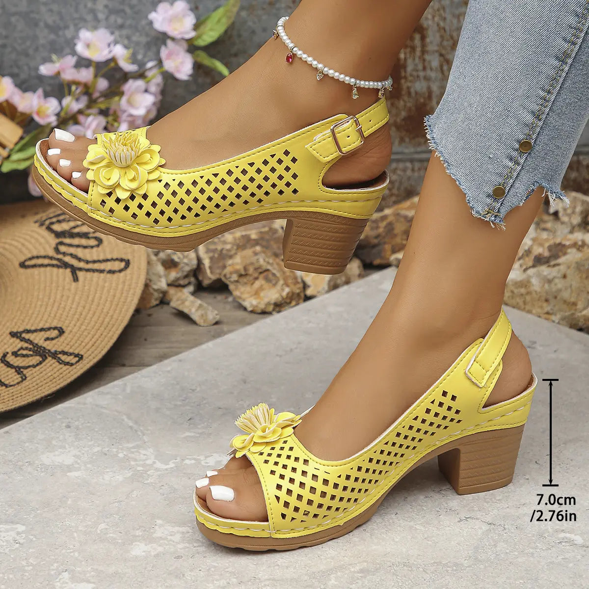 Kaelia yellow peep-toe chunky heel sandals with floral embellishment and square perforations, shown on a model's feet with a 7cm heel height annotation.