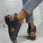 Kaelin navy blue faux leather platform wedge sandals with adjustable ankle strap and peep-toe design, shown on a woman wearing denim jeans.