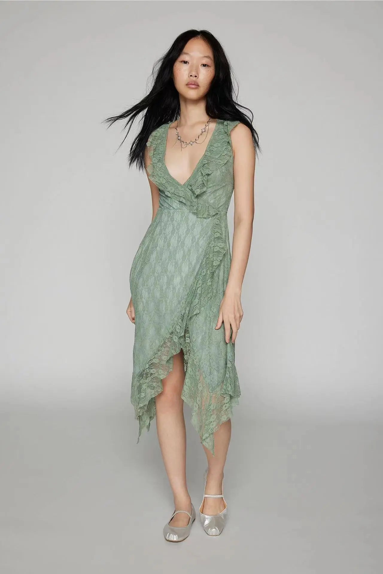 Kaelis women's sleeveless green lace midi dress featuring a deep V-neckline with cascading ruffles and an asymmetrical tiered ruffle hem, shown from the front.