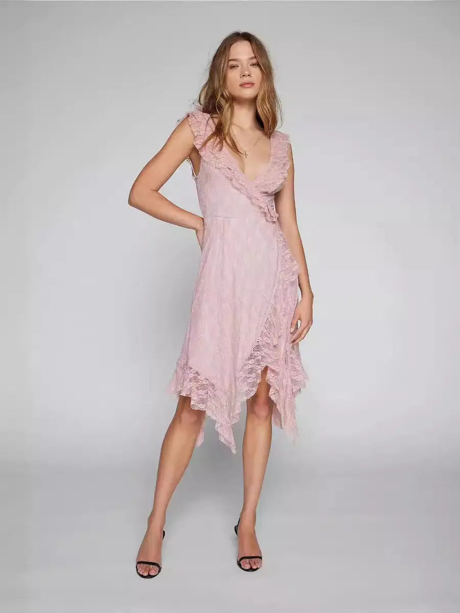A Kaelis pink lace V-neck midi dress with cascading ruffles and an asymmetrical tiered hem, shown on a model in a studio. The sleeveless design features delicate ruffled shoulder straps.