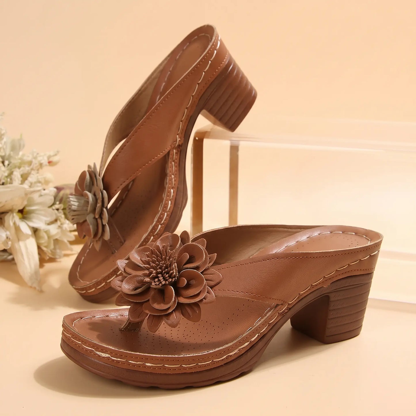 Kaelis Rich Tan women's slide sandals featuring a single wide strap with a large 3D fabric flower embellishment, a stacked block heel, and layered sole.