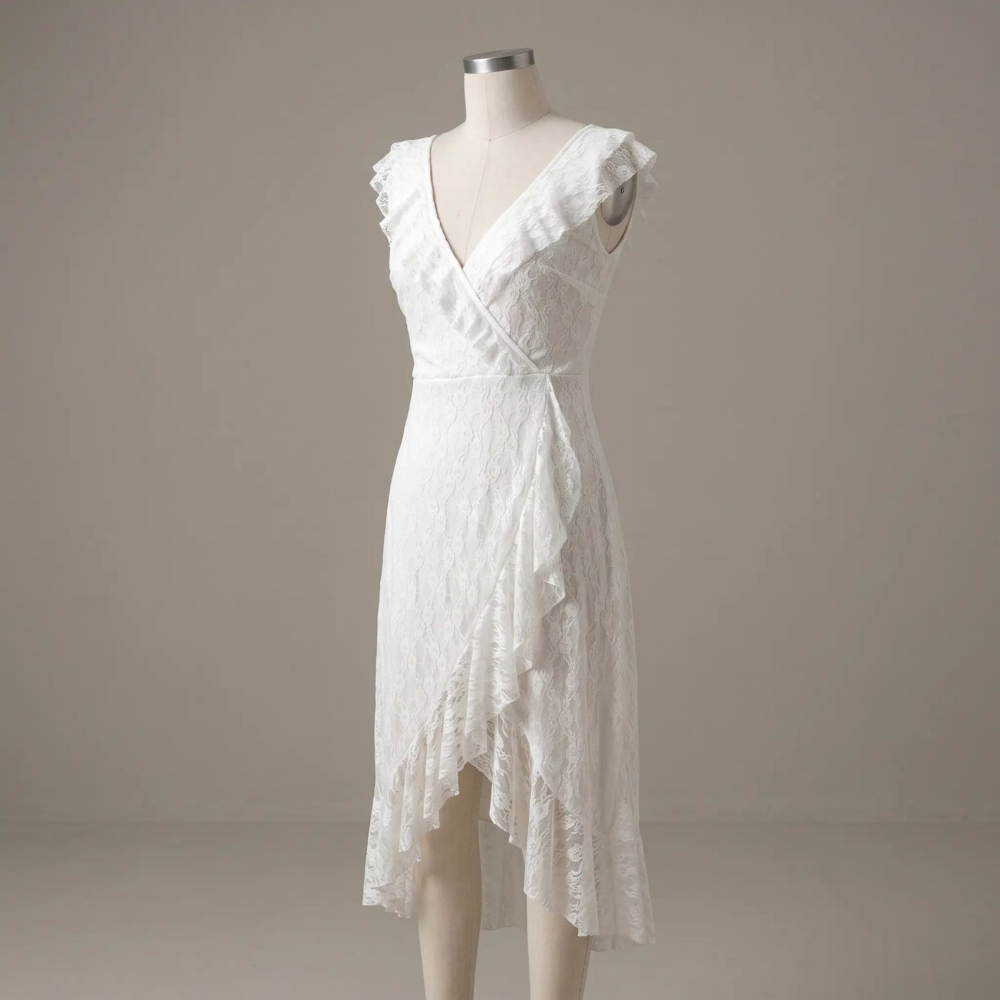 Kaelis white lace V-neck midi dress featuring cascading ruffled V-neckline, sleeveless design, and an asymmetrical tiered ruffle hem, displayed on a mannequin.