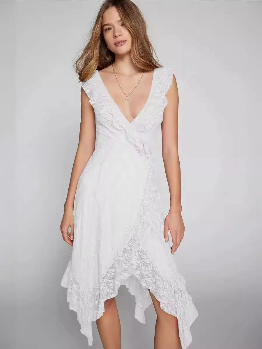 Kaelis white lace V-neck midi dress with cascading ruffles and an asymmetrical tiered ruffle hem, shown on a model with a studio background.