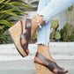 Kaelo women's dark brown faux leather criss-cross strap wedge sandals featuring a multi-colored flecked cork platform and wedge heel, worn with light blue frayed jeans.