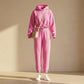 Kaelo women's cropped hoodie and jogger set in pink fleece, front view showing the adjustable toggle waist and high-rise fit styled with sneakers.