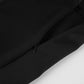 Close-up view of the matte black fabric and hidden side zipper detail on Kaelon high-waisted tailored shorts.