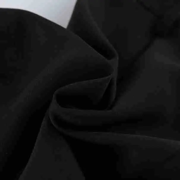 Close-up view of the matte black polyester-spandex blend fabric of Kaelon high-waisted shorts, highlighting its smooth texture and subtle weave detail.