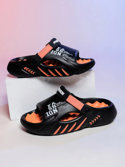 Kaelos black EVA slide sandals with vibrant orange accents, featuring embossed white text 'FASHION' and 'LIFE IS BEAUTIFUL' on the straps, displayed from a front-facing perspective.