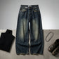 Kaelos high waisted wide leg jeans in vintage wash denim, flat lay styling with black turtleneck and leather boots.