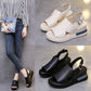 A woman models black Kaelos wedge sandals with a crossover peep-toe and slingback strap, complemented by separate studio shots of black and off-white variants.