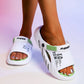 Kaelos white EVA slide sandals with lime green accents, featuring embossed 'FASHION' and 'LIFE IS BEAUTIFUL' text on the strap, worn on feet against a studio background.