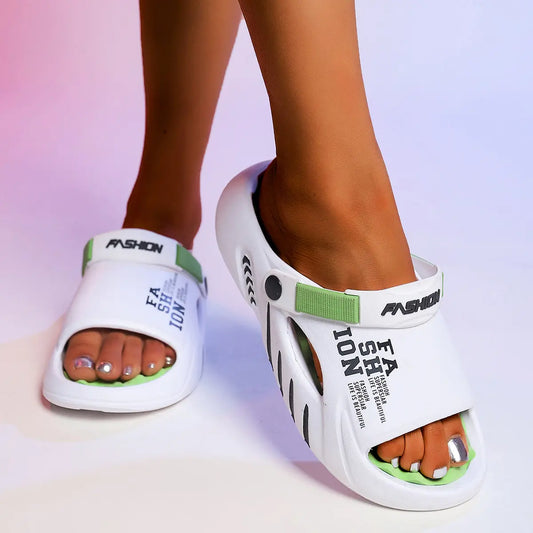 Kaelos white EVA slide sandals with lime green accents, featuring embossed 'FASHION' and 'LIFE IS BEAUTIFUL' text on the strap, worn on feet against a studio background.