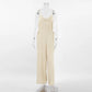 Kaelum oatmeal beige linen-blend wide-leg jumpsuit featuring a V-neckline, adjustable spaghetti straps, and side tie details, shown from the front.
