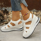 Women's white Kaelum platform wedge sandals with three cut-out straps and hook-and-loop closures, shown from a three-quarter angle in a lifestyle setting.