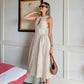 Elegant Kalira linen blend midi dress in natural beige, featuring a sleeveless design, keyhole neckline with button detail, and a flattering gathered A-line skirt worn by a model.