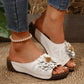 White Kavlo women's slide sandals featuring a 3D fabric flower embellishment on the vamp, open toe, and a low wedge platform sole, shown styled with denim jeans and a pearl anklet.