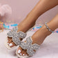 Kezia Ivory Pearl embellished flat sandals featuring dazzling pearl and rhinestone details on a wide strap, shown on a model's feet with a square toe design and slip-on style.