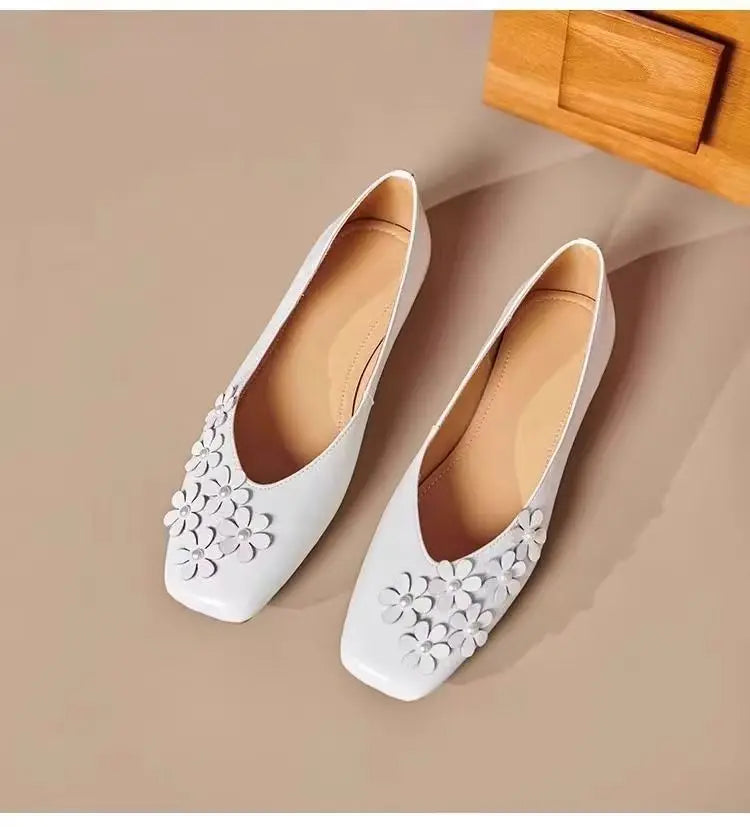 Overhead view of two Ivory Pearl Khyzet floral square toe flats, crafted from smooth vegan leather with delicate tonal appliques and pearl centers.