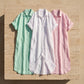 Kivaro linen blend maxi shirt dresses in mint green, pristine white, and blush pink. Flat-lay on stone, showcasing relaxed fit and rolled sleeves.