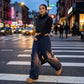 Kovara thermal quilted wide-leg trousers in navy blue, worn by a model in an urban street setting showing the diamond stitching and relaxed fit.