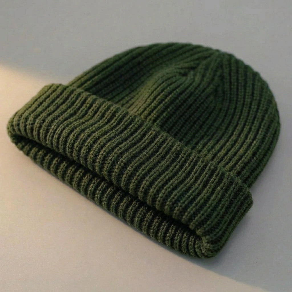 Kovari docker beanie fisherman hat in army green ribbed knit — three-quarter view showing rolled cuff and textured crown.
