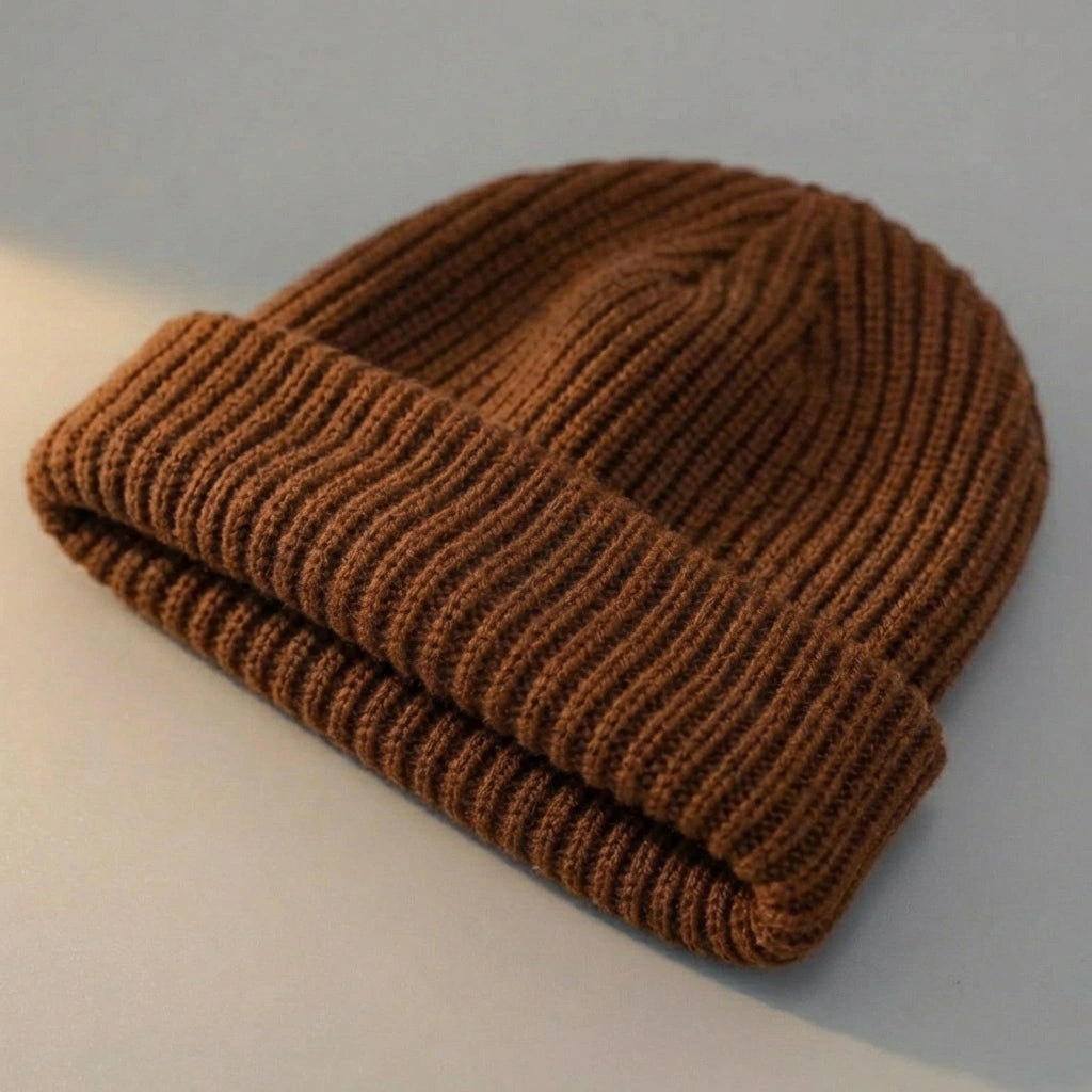 Kovari docker beanie fisherman hat in brown ribbed knit — three-quarter view showing the rolled cuff and textured weave.