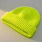 Kovari docker beanie fisherman hat in neon lemon green ribbed knit — three-quarter view showing rolled cuff and texture.