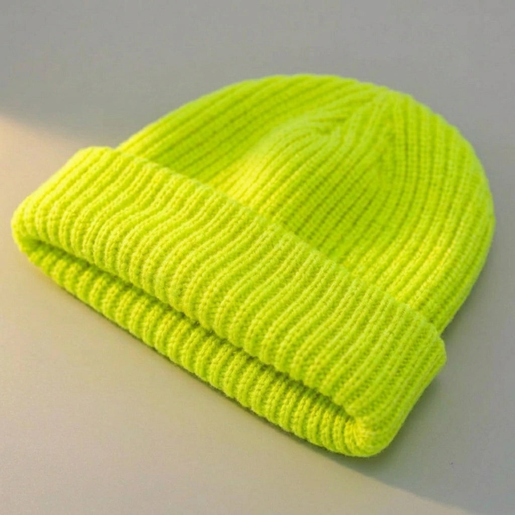 Kovari docker beanie fisherman hat in neon lemon green ribbed knit — three-quarter view showing rolled cuff and texture.