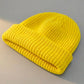 Kovari Docker Beanie fisherman hat in lemon yellow ribbed knit — three-quarter view showing the rolled cuff and structured crown.