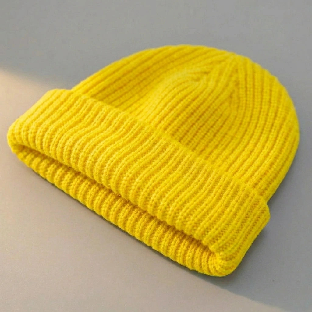 Kovari Docker Beanie fisherman hat in lemon yellow ribbed knit — three-quarter view showing the rolled cuff and structured crown.