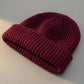 Kovari Docker Beanie fisherman hat in burgundy wine ribbed knit — three-quarter view showing the thick rolled cuff and structured crown.