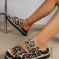 Women's Kovari leopard print platform slide sandals with double antique gold buckles shown on feet, featuring a 4cm platform.
