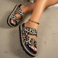 Women's Kovari leopard print platform slide sandals worn by a model, showcasing the double buckle detail and chunky sole in a lifestyle setting.