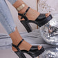 Model wearing black Kylos platform high heel sandals with chunky block heel and ankle strap, styled with distressed denim jeans and disco ball decor.