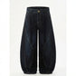 Kyro architectural curved leg jeans in midnight indigo heavyweight denim — front view showing the signature scythe seams and voluminous balloon silhouette.