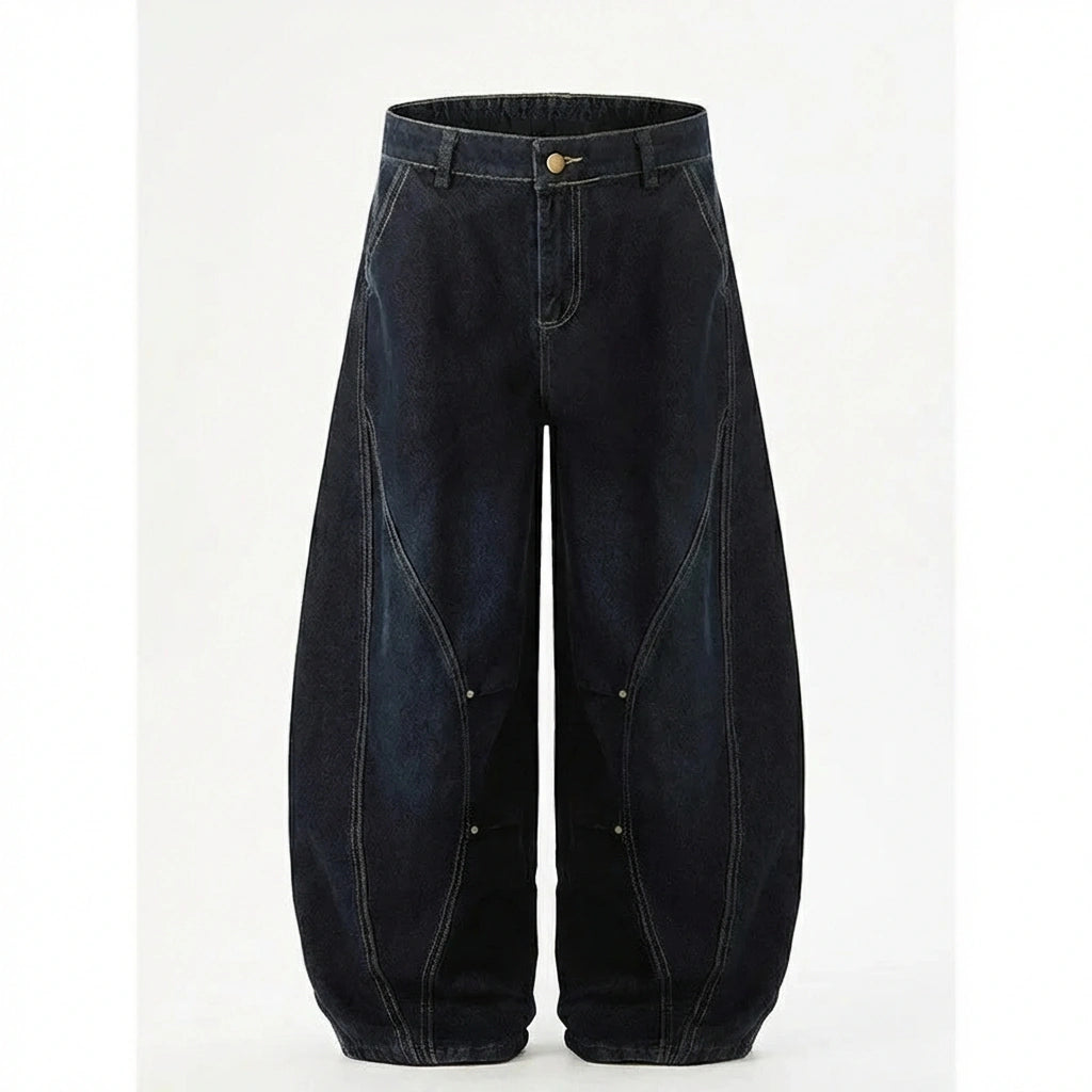 Kyro architectural curved leg jeans in midnight indigo heavyweight denim — front view showing the signature scythe seams and voluminous balloon silhouette.