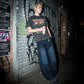 Kyro architectural curved leg jeans in midnight indigo worn by a model in an urban setting, showing the relaxed balloon fit and contrast stitching details.