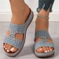Light blue Briska laser-cut wedge sandals worn by a woman showing intricate geometric patterns and decorative studs on a light grey floor.