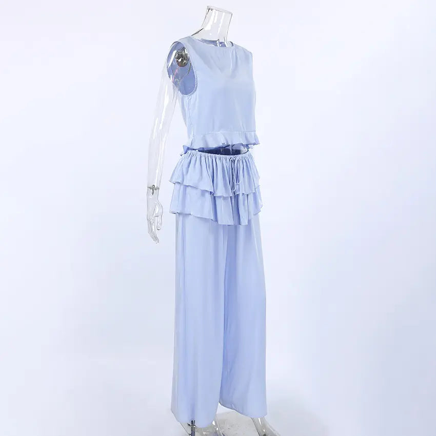Three-quarter side view of a light blue Zelphira sleeveless ruffled crop top and matching wide-leg trousers set displayed on a mannequin.