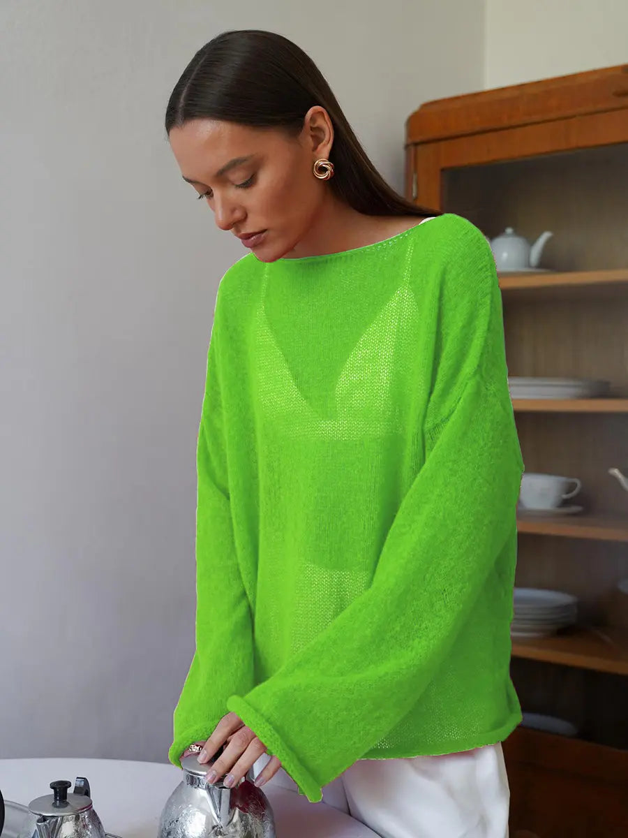 Model wearing Zomari's vibrant lime green sheer open-knit bell sleeve sweater, featuring a wide boat neckline and dropped shoulders, in an elegant indoor setting.