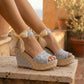 Luminous Silver Lace espadrille platform wedge sandals worn by a model. Features intricate silver lace upper straps, sheer ribbon ankle ties, and a woven espadrille platform in an outdoor setting.