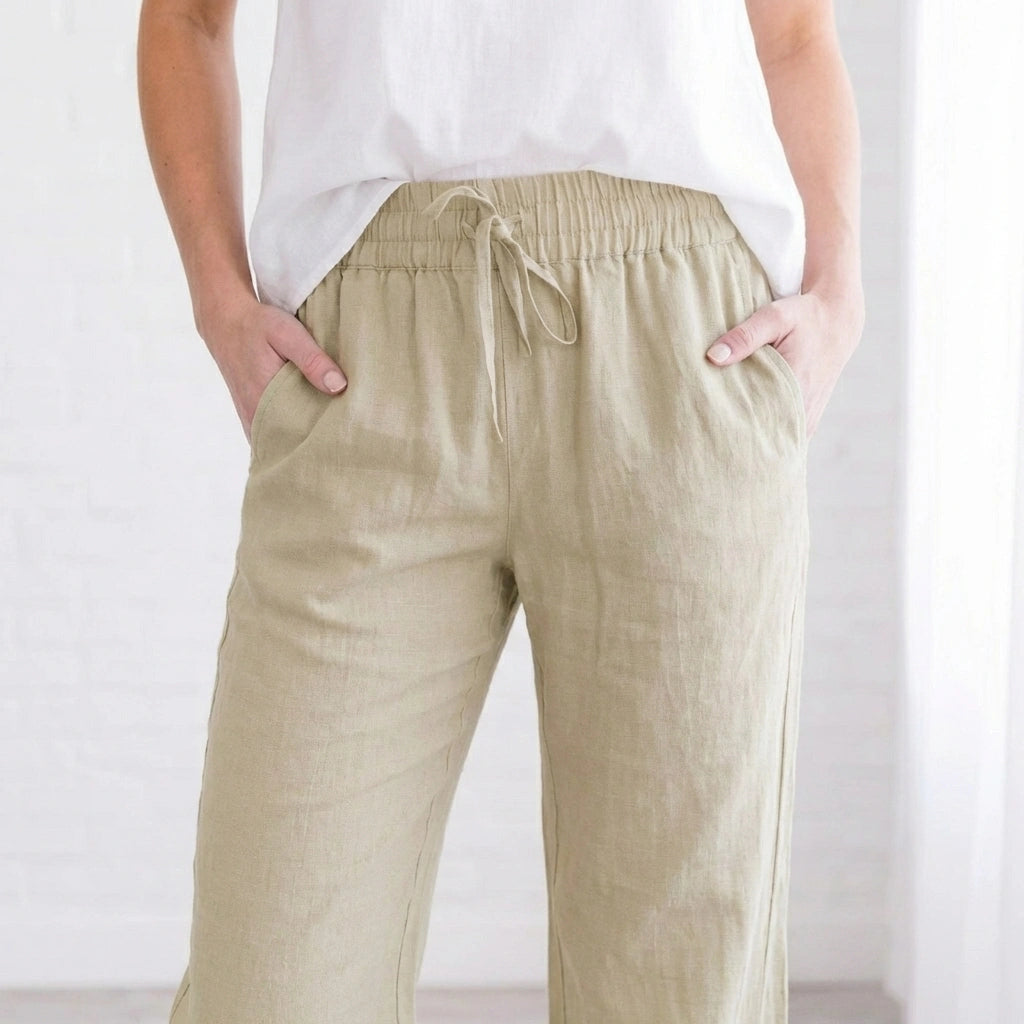 Luvana linen blend trousers in light khaki with an elastic waist and drawstring, shown from the front on a model.