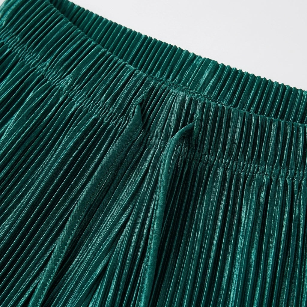 Close-up of the elasticated waistband and vertical micro-pleated texture of Luvia wide leg pleated trousers in deep teal with drawstring.
