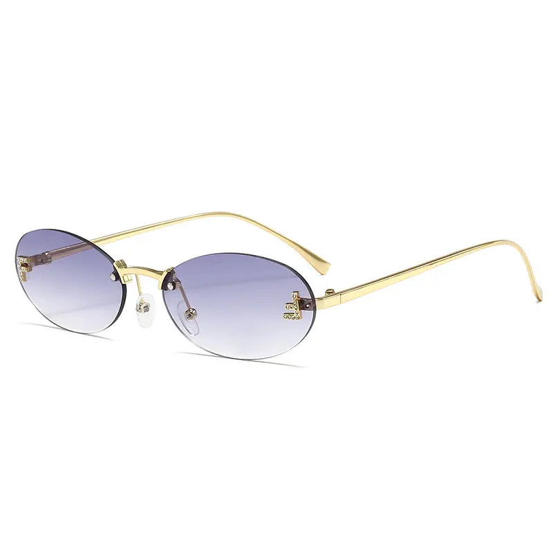 Elegant oval rimless sunglasses featuring thin gold metal frames and gradient purple-blue lenses, with subtle jeweled letter embellishments on the temples, presented from a three-quarter angle.