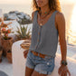 Makori Charcoal Grey sleeveless V-neck textured tank top with faux-wood buttons and a chest pocket, worn by a model in a relaxed outdoor setting.