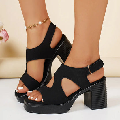 Mekari black suede-finish platform sandals on model, featuring an open toe, V-cut forefoot strap, ribbed block heel, and hook-and-loop ankle strap.